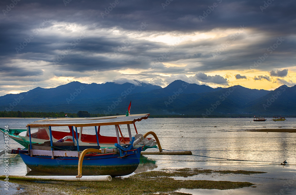 Indian ocean, low tide, fishing boats. Indonesia Gili Air. Early morning, low tide.
