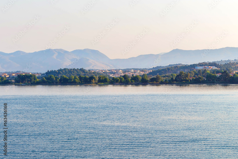 Sea view to city on Corfu island, Greece. Sunset