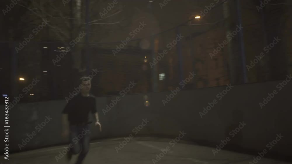 Young guy runs on the street at night Young guy runs on the street at night