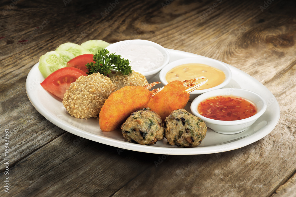 Mixed food platter with fried crab claws, sesame balls & meat balls