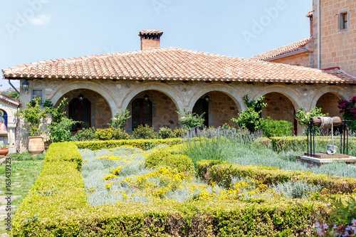 Old monastery garden full of flowers. Corfu island, Greece photo