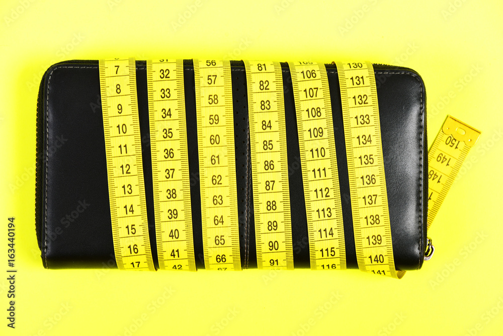 Φωτογραφία Concept of fashion and savings with black wallet and tape