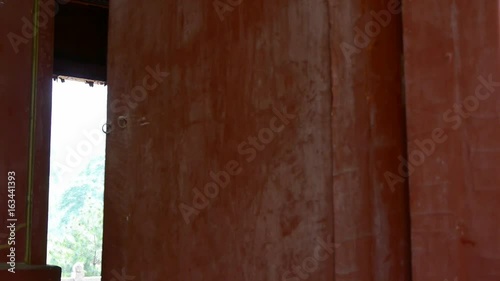 Close red wooden door,old wood texture,historical artifacts.