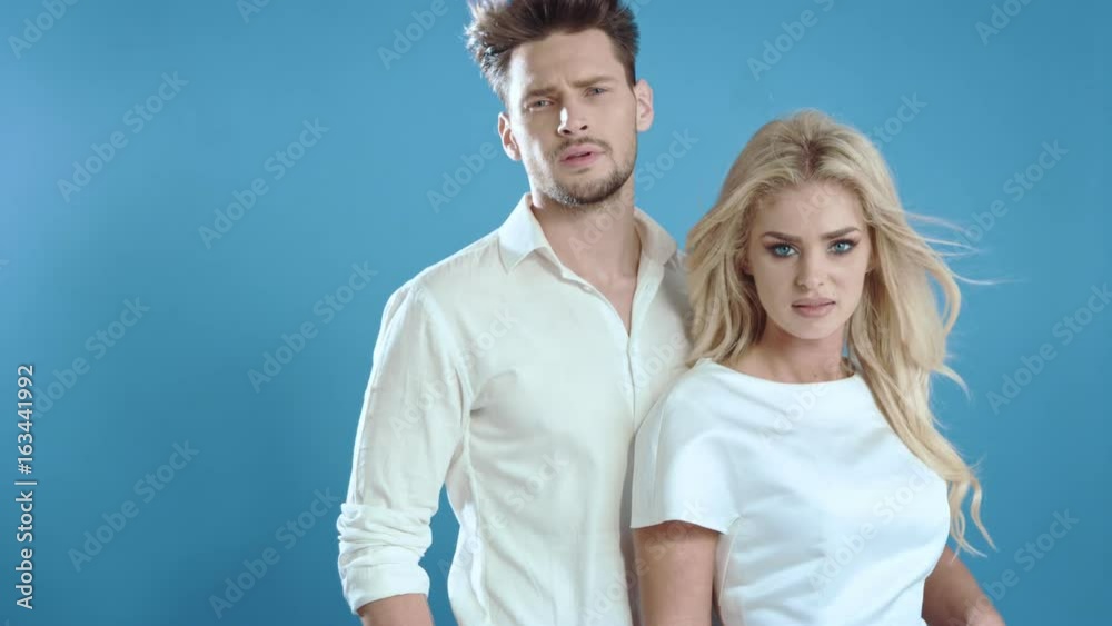 Sexy young couple posing on studio background, 4k slow motion studio clip Sexy young couple posing on studio background, 4k slow motion studio clip
