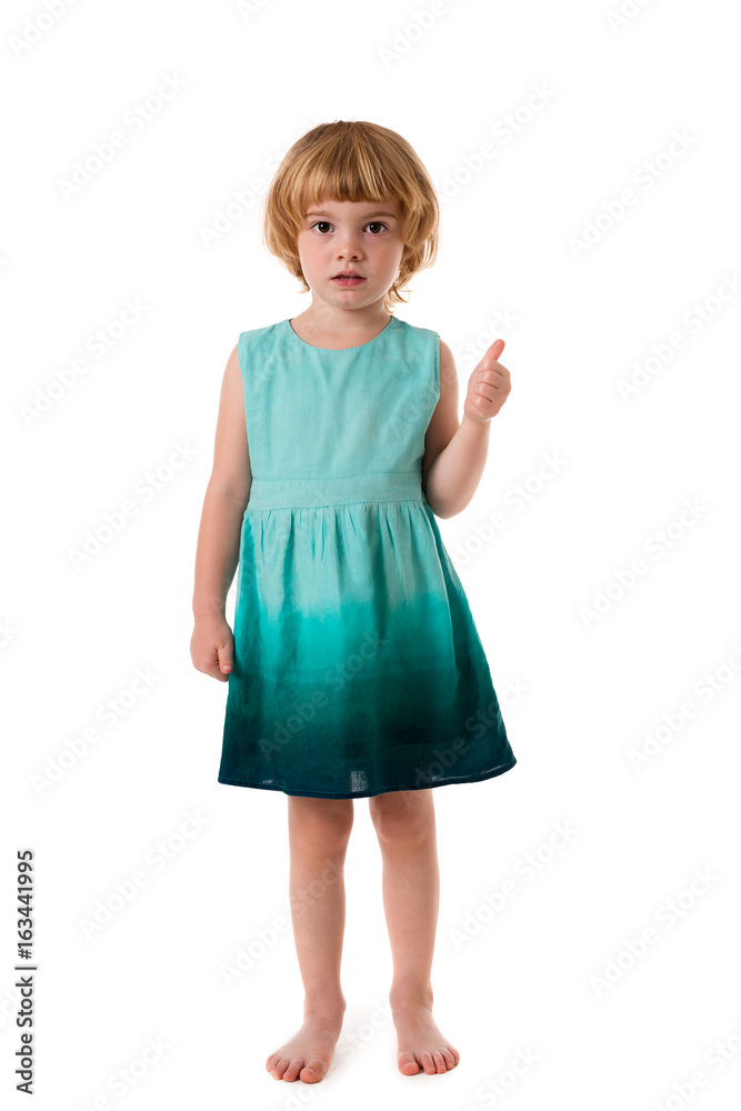 Cute little girl standing and showing thumbs up.Isolated Cute little girl standing and showing thumbs up.Isolated