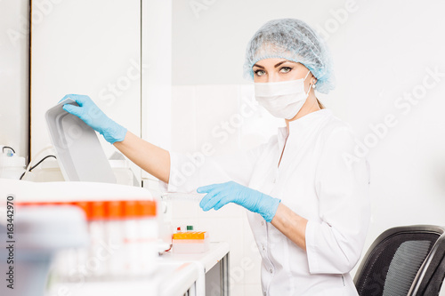 Focused young life researcher with laboratory equipment