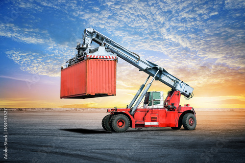  Logistics import export background of container handling forklifts at the dock