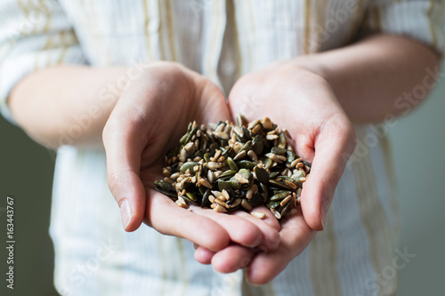 Close Up Of Woman Holding Handful Of Healthy Seeds
