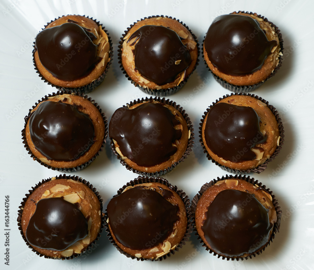 Set of tasty chocolate frosting cakes isolated on white. Top view Set of tasty chocolate frosting cakes isolated on white. Top view