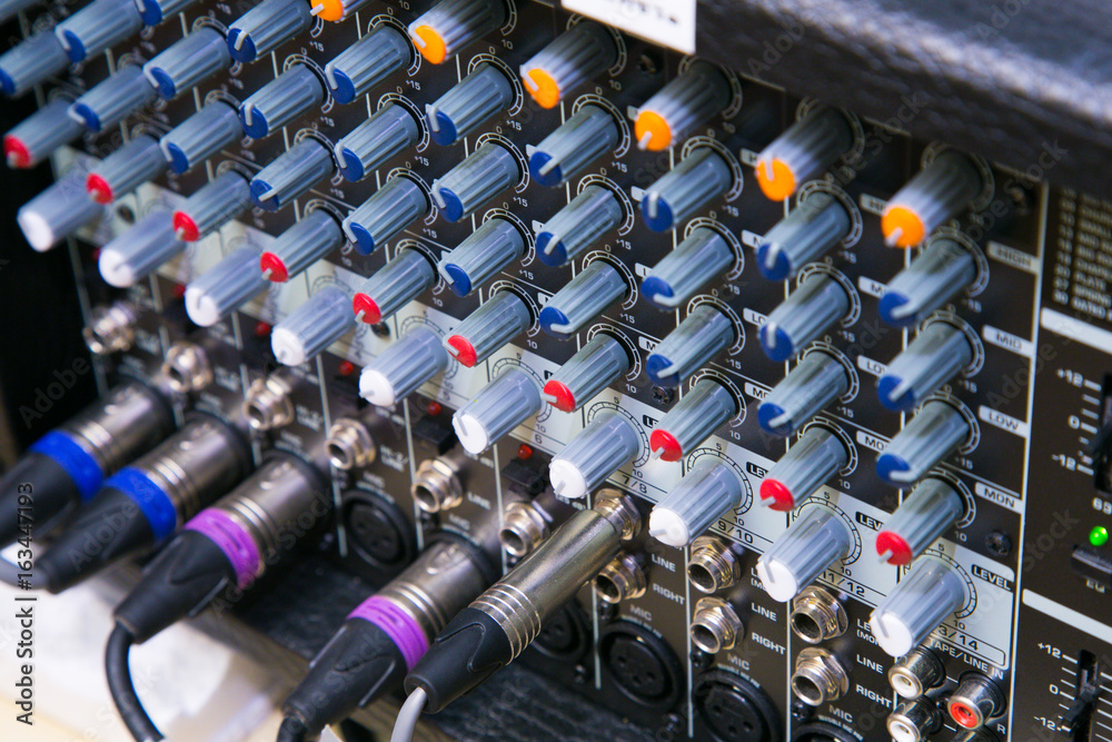 Fototapeta premium Buttons and tabs in various parts of the audio controller mixer ,music,mixer in studio,audio sound mixer with buttons and sliders