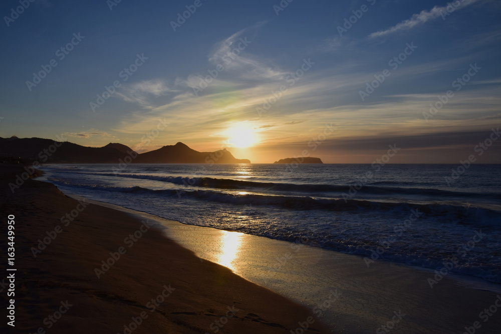 Sunrise over the headland of Porto Santo Beach, Madeira