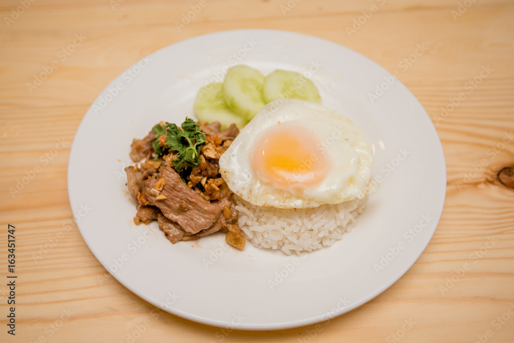 Pork fried garlic with rice and fried egg, Thai food Pork fried garlic with rice and fried egg, Thai food