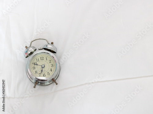 old clock on bed in morning