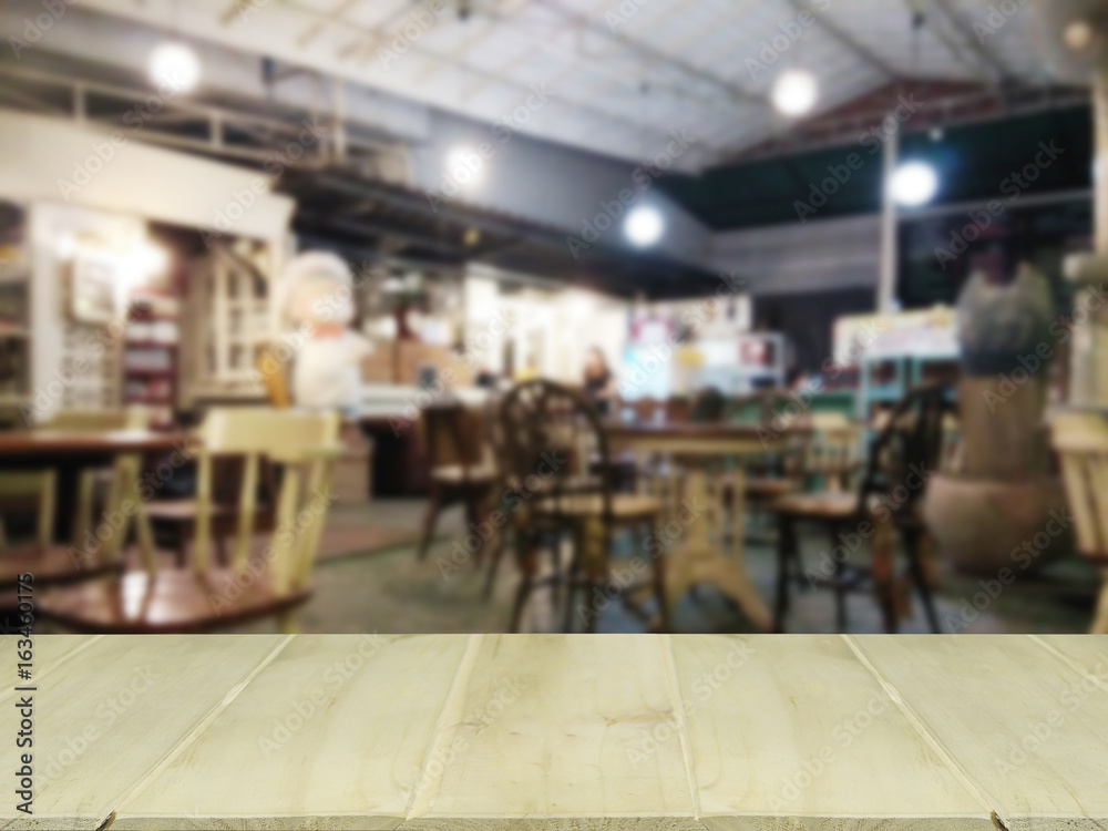 wooden table with blur coffee shop Background