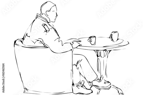  man in a chair drinking tea in a cafe