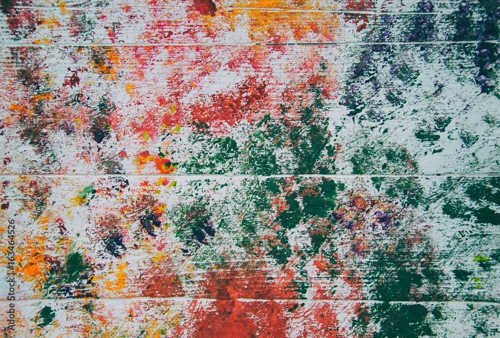 Abstract red, orange and green on wood panel background