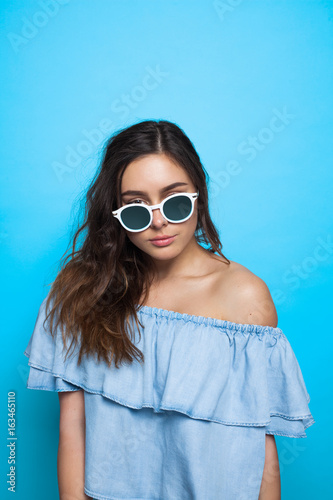 Attractive girl looking over sunglasses