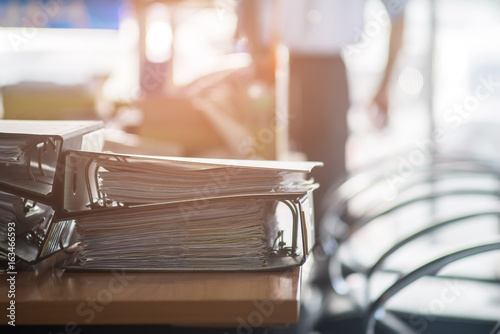 Pile of unfinished documents on office desk, Stack of business paper,Business Concept © chaiya