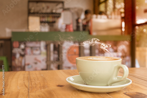 hot coffee cup on wooden in coffee shop background
