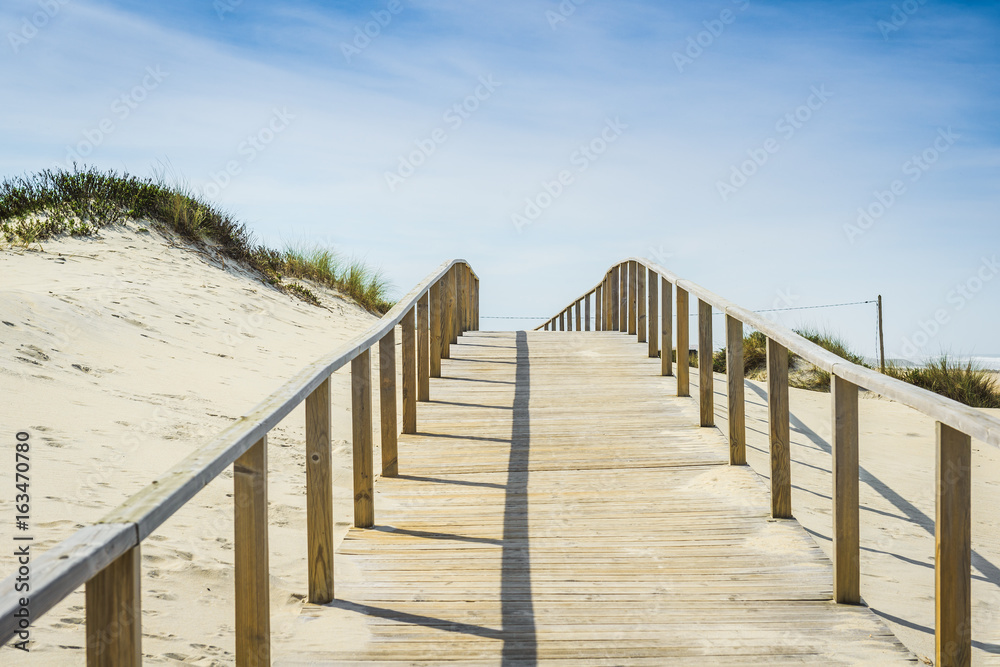Beach path between sand dunes at Costa Nova beach. Aveiro. Portugal Beach path between sand dunes at Costa Nova beach. Aveiro. Portugal