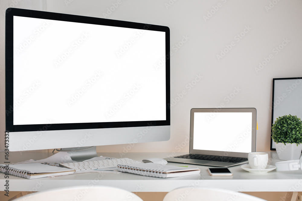 Fototapeta premium Modern desktop with computer and laptop