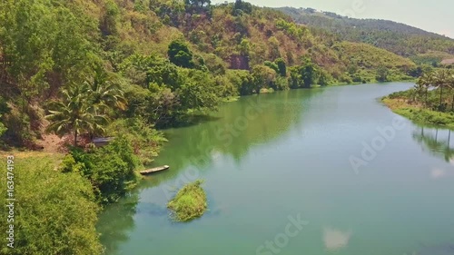 Flycam Shows Green River against Dense Jungle in Vietnam Pongour photo