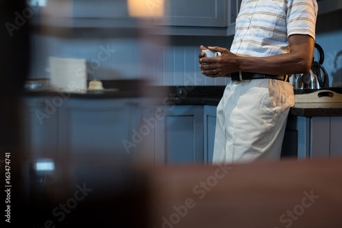 Midsection of man having coffee photo