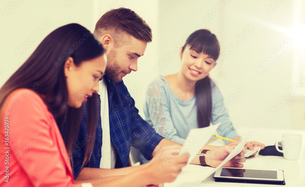 happy creative team or students working at office happy creative team or students working at office