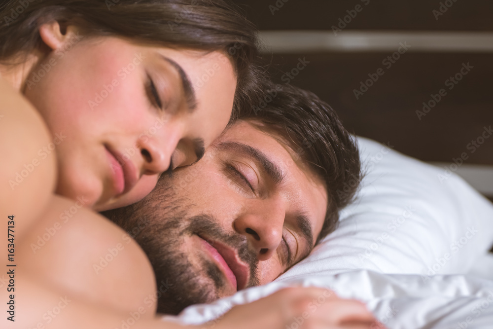 The happy couple relax in the bed The happy couple relax in the bed
