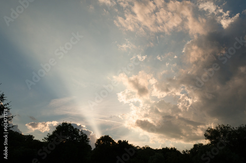 rays of sunlight through clouds outdoor. cloudy sky in summer