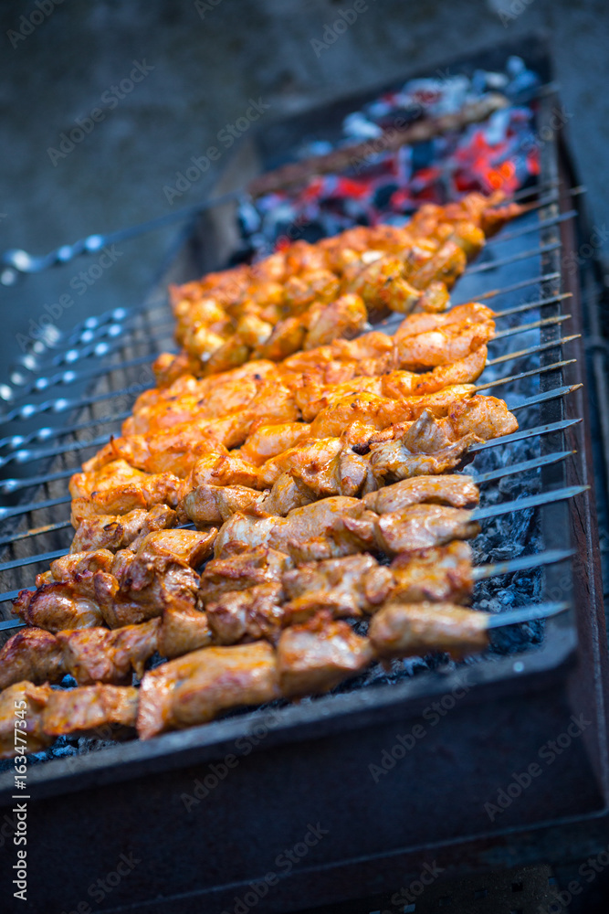Barbecue. Fried shish kebab from pork meat. Fried chicken meat. Lamb on charcoal