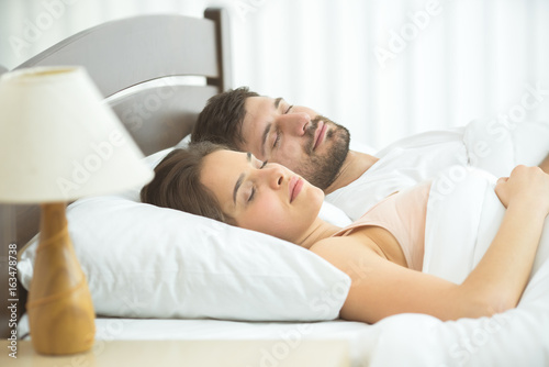 The man and woman sleeping in the bed. full grip focus