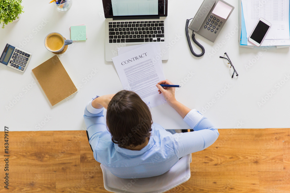 businesswoman signing contract document at office businesswoman signing contract document at office