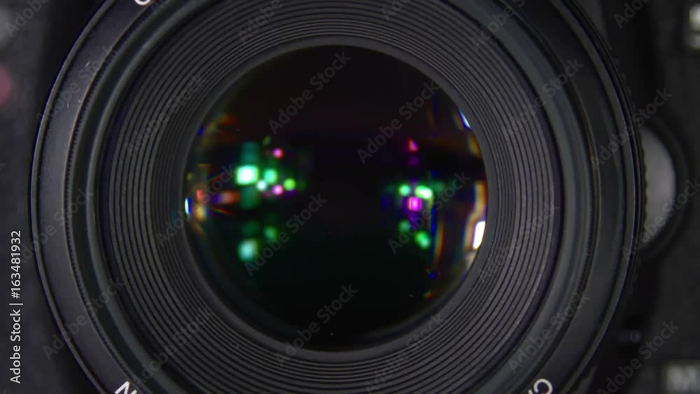 The camera during shooting. The camera while shooting macro. The camera is in the process of close-up shooting. Shutter release in slow motion.