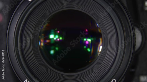 The camera during shooting. The camera while shooting macro. The camera is in the process of close-up shooting. Shutter release in slow motion.