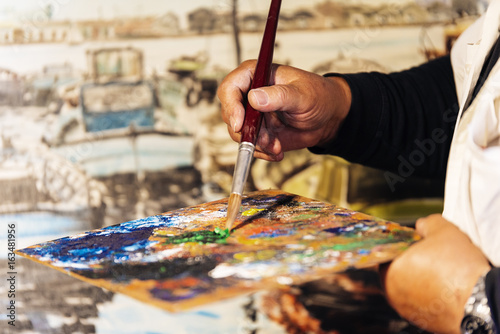 Bild auf Leinwand Close up of man artist painting oils in his studio.