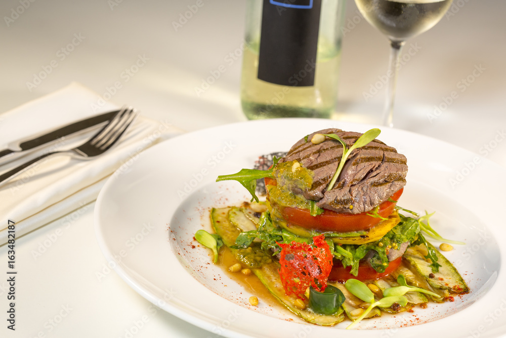 Grilled meat with vegetables served as a sandwich. Grilled meat with vegetables served as a sandwich.