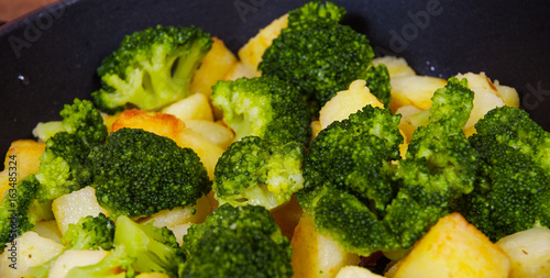 Broccoli with potatoes in a frying pan 