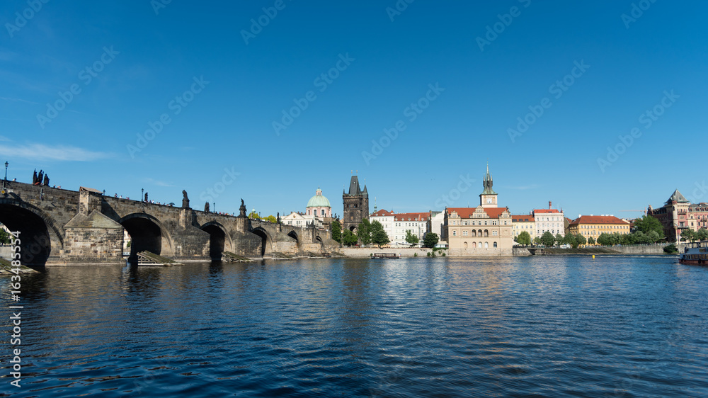 Charles Bridge, tower, and Vltava embankment viewed from the river, Prague