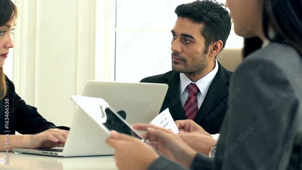 A group of businessmen & women having a business discussion meeting, strategy and presentation in the company’s boardroom