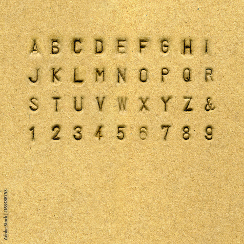 Sans-serif alphabet punched on cardnoard