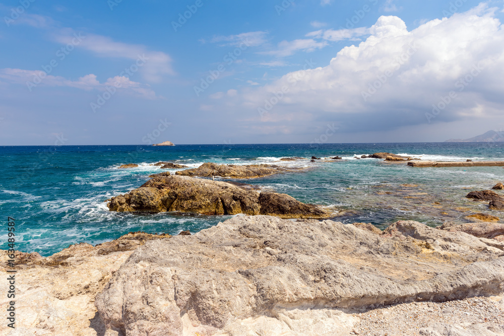 Rocky coast and turquoise sea water in Mandrakia village on Milos island. Greece.