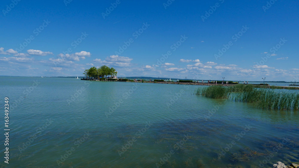 Sunset over the balaton lake. It is one of the largest lakes in Hungary - a common summer point of the spill. A place of life for many species of birds and fish.