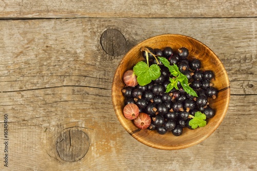 Fresh black currant on a wooden table. Healthy fruit, full of vitamins and antioxidants. Healthy food.