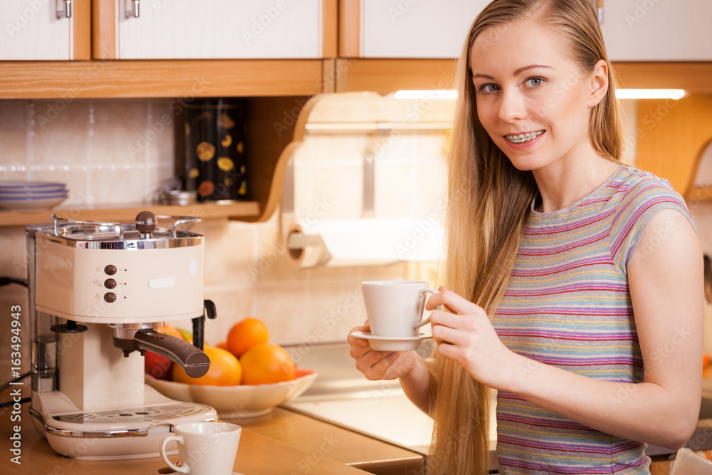 Happy woman holding cup of tea of coffee