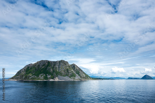 Godoy. Godoy is the southernmost and westernmost of the islands in the municipality of Giske, Norway. It is famous for its beautiful nature, dominated by the 497 meter tall mountain Storhornet.