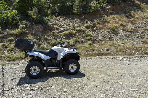 ATV offroad on mountain and sky background.