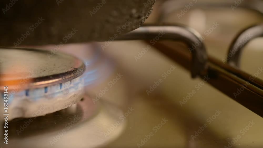 Dirty gas stove burners in kitchen room.