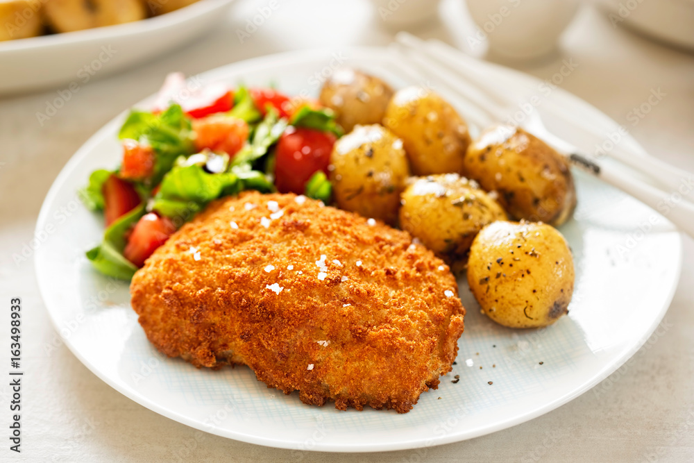 Traditional breaded fillet of cod with baby potatoes and salad Traditional breaded fillet of cod with baby potatoes and salad