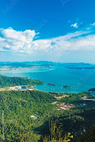 Fototapeta Naklejka Na Ścianę i Meble -  View of blue sky, sea and mountain seen from Cable Car viewpoint, Langkawi, Malaysia. Picturesque landscape with town among the tropical forest, beaches, small Islands in waters of Strait of Malacca